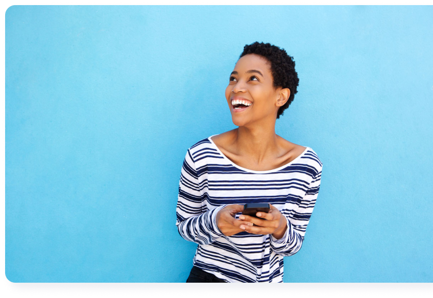 Black Woman Holding Phone Looking Up Smiling With Blue Background | Qube Money